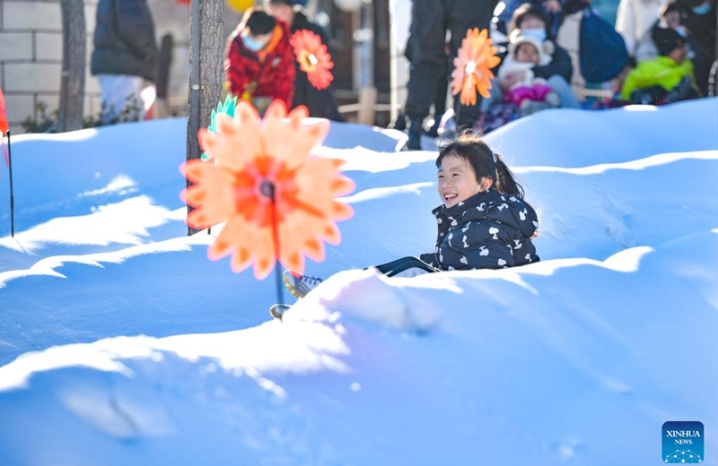 A child enjoys a snow activity at a theme park in Jizhou District, north China's Tianjin, Jan. 2, 2023. (Photo by Wang Jinyi/Xinhua)