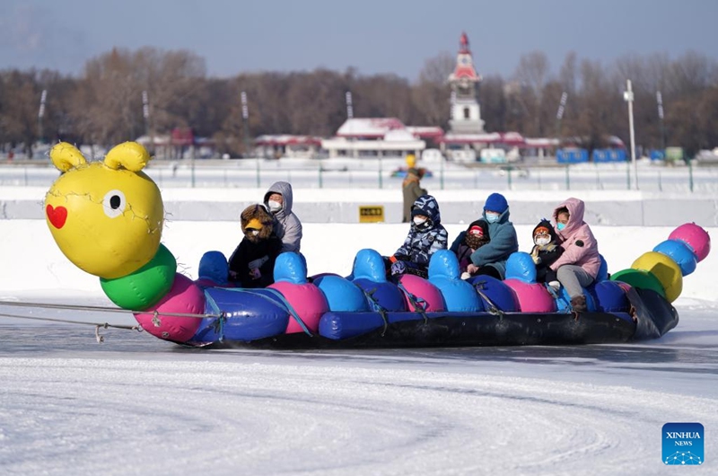 Tourists play at the Ice and Snow Carnival park on the Songhua River in Harbin, northeast China's Heilongjiang Province, Jan. 1, 2023. (Xinhua/Wang Jianwei)