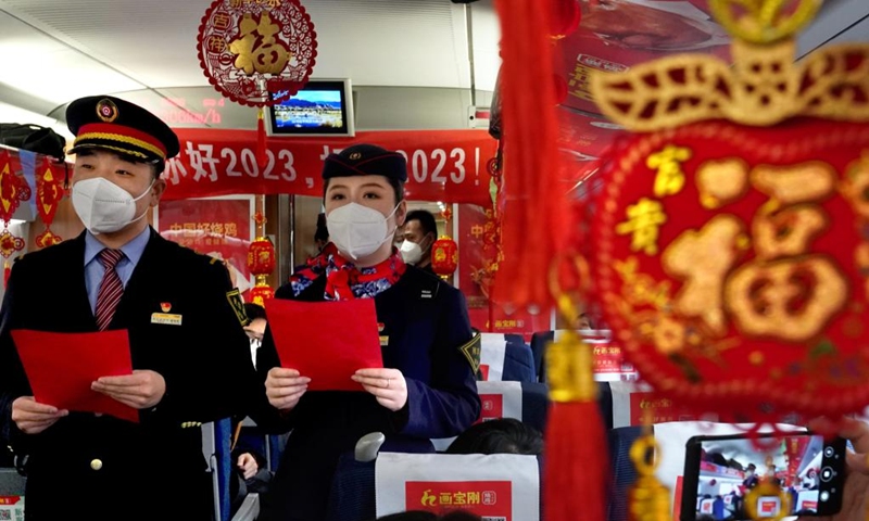 Crew members stage a performance on the train G2023 running from Shangqiu in central China's Henan Province to Lanzhou in northwest China's Gansu Province, Jan. 1, 2023. Various activities to celebrate the new year were held on the train G2023 as the number of the train coincides with the year of 2023. (Xinhua/Li An)