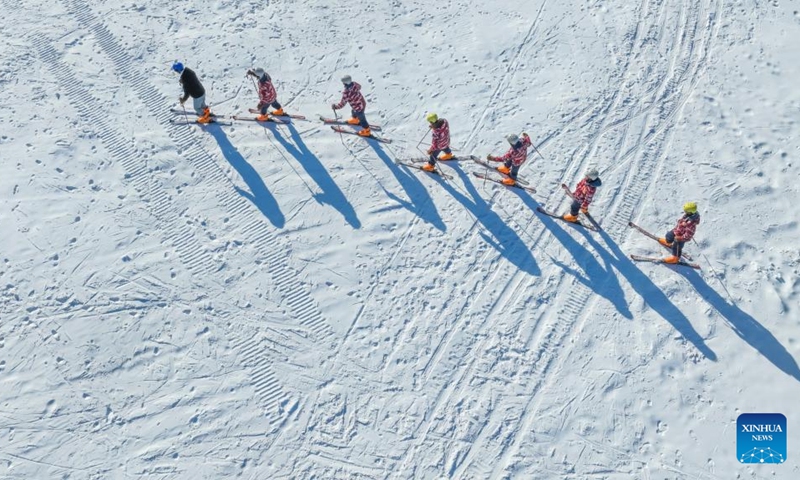 This aerial photo shows people skiing at a ski resort in Zunhua, north China's Hebei Province, Dec. 31, 2022. (Photo by Liu Mancang/Xinhua)
