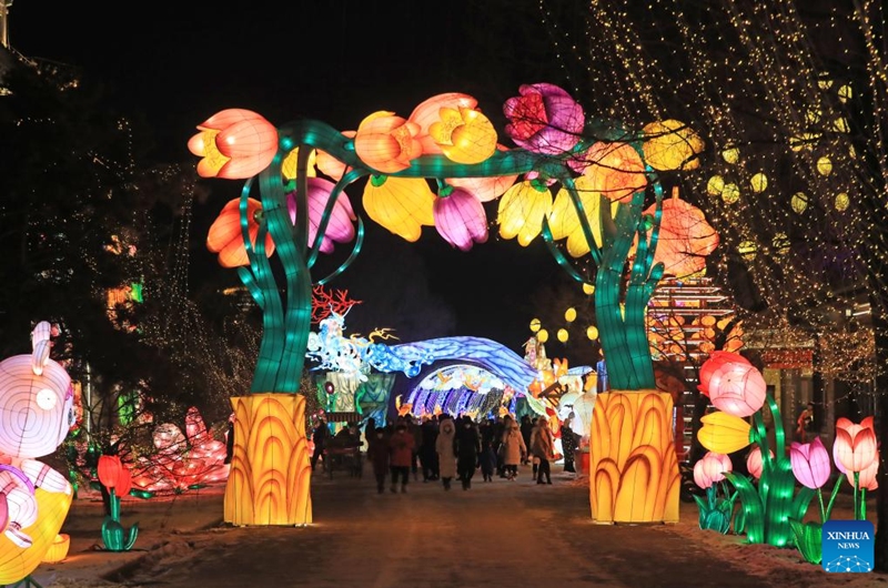 People visit a lantern display in Shenyang, northeast China's Liaoning Province, December 31, 2022. A lantern display to greet the upcoming Spring Festival started here on December 30, 2022.  Covering more than 20,000 square metres, the lantern became the center of attention for visitors, with more than 70 large lighting installations illuminating the city's night sky.  (Xinhua/Yang Qing)