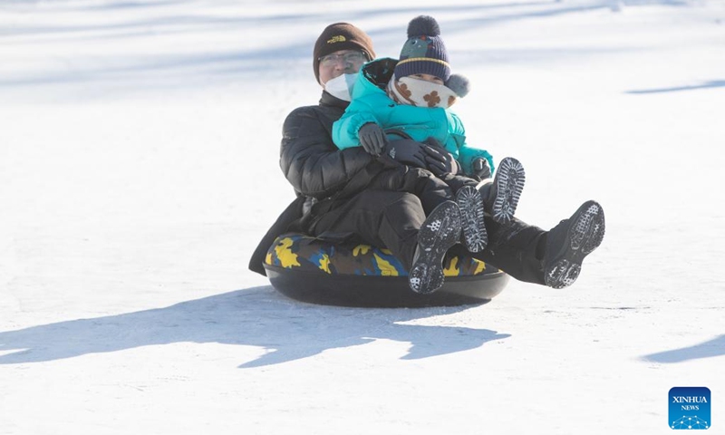 Tourists play at the Ice and Snow Carnival park on the Songhua River in Harbin, northeast China's Heilongjiang Province, Jan. 1, 2023. (Xinhua/Zhang Tao)