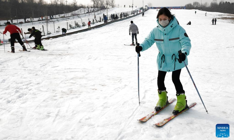 A woman enjoys skiing at a ski resort in Jiyuan, central China's Henan Province, Jan. 2, 2023. (Photo by Miao Qiunao/Xinhua)