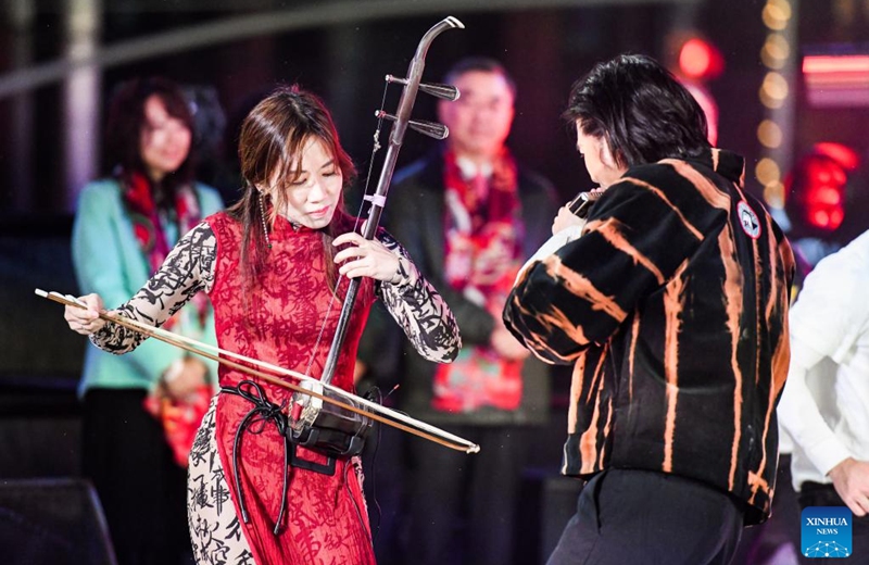 An artist from China's Hong Kong Special Administrative Region plays Chinese musical instrument Erhu during the Times Square New Year's Eve celebration in Manhattan, New York, the United States, Dec. 31, 2022. Artists from Hong Kong kicked off the countdown celebration on the eve of 2023 in Times Square. The performance with the theme of Fusion, Motion, Inspiration - Hong Kong Rocks blended music, dance, parkour, capoeira and others against a newly created medley. (Photo by Ziyu Julian Zhu/Xinhua)