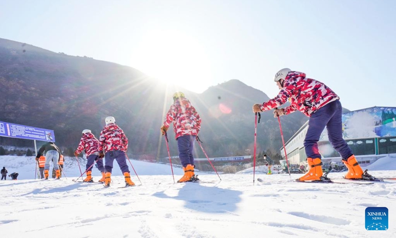 People ski at a ski resort in Zunhua, north China's Hebei Province, Dec. 31, 2022. (Photo by Liu Mancang/Xinhua)