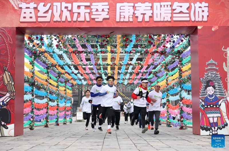 People take part in a running activity to celebrate the New Year in Danzhai County of Qiandongnan Miao and Dong Autonomous Prefecture, southwest China's Guizhou Province, Jan. 1, 2023. (Photo by Huang Xiaohai/Xinhua)