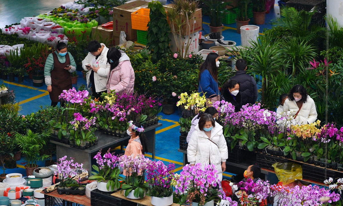 People browse flower bouquets inside the Dounan Flower Market, China's largest fresh flower trading hub, in Kunming, Southwest China's Yunnan Province on January 2, 2023 ahead of the Spring Festival holidays. Dubbed the 