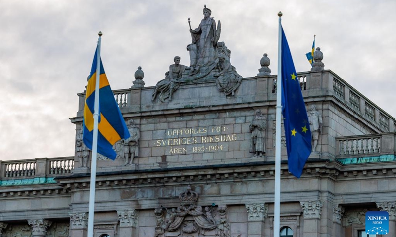 The flags of the European Union (EU) and Sweden are seen outside the Swedish Parliament in Stockholm, Sweden, Jan. 1, 2023. Sweden on Sunday took over from the Czech Republic at the helm of the six-month rotating Presidency of the Council of the EU. Sweden will hold the presidency for six months until June 30, 2023. (Photo by Wei Xuechao/Xinhua)