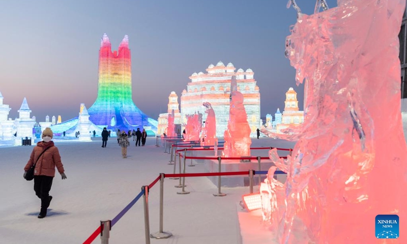 Tourists look at ice sculptures at the Harbin Ice-Snow World theme park in Harbin, northeast China's Heilongjiang Province, Jan. 5, 2023. A competition, featuring ice sculptures with exquisite craftsmanship from 12 sculptor teams, concluded here on Saturday. (Xinhua/Xie Jianfei)