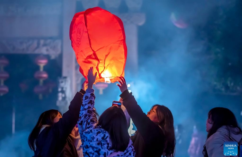 People release a sky lantern to make a wish for good fortune at a park in Qianxi, southwest China's Guizhou Province, Jan. 1, 2023. (Photo by Fan Hui/Xinhua)