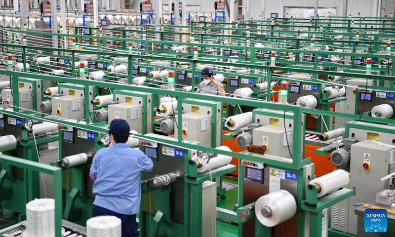 Employees work at a fiberglass workshop of a glass products company in Shahe City, north China's Hebei Province, Jan. 6, 2023. Glass products companies in Shahe have stepped up production to guarantee the completion of orders from domestic and foreign customers at the beginning of the new year. (Xinhua/Mu Yu)