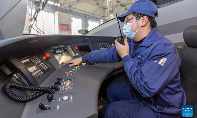 A worker carries out maintenance at the Hongqiao high-speed train depot in east China's Shanghai, Jan. 3, 2023. Railway workers of the Hongqiao high-speed train depot have stepped up their efforts on maintenance work for trains to prepare for the future travel rush during the Chinese Lunar New Year.(Photo: Xinhua)