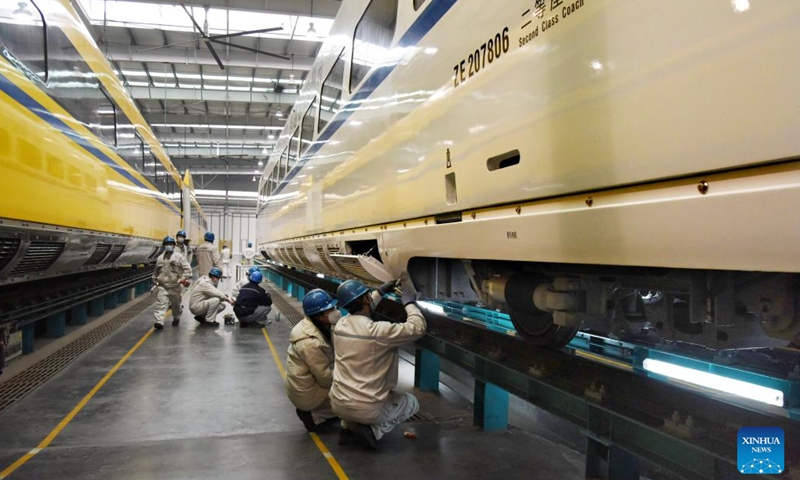Technicians debug a train at a workshop of CRRC Qingdao Sifang Co., Ltd. in Qingdao, east China's Shandong Province, Jan. 4, 2023. As a major manufacturer of high-speed trains in China, CRRC Qingdao Sifang Co., Ltd. overhauled the trains that will serve the upcoming Spring Festival travel rush to ensure their smooth operation.(Photo: Xinhua)
