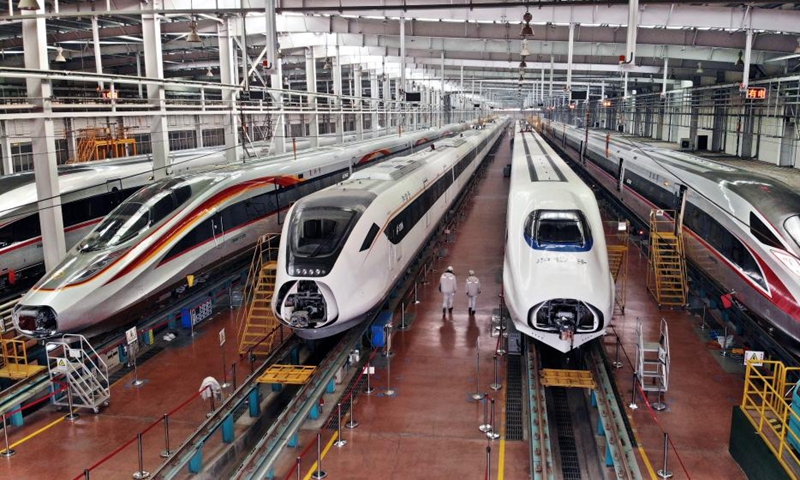 This aerial photo taken on Jan. 4, 2023 shows bullets trains at a garage of CRRC Qingdao Sifang Co., Ltd. in Qingdao, east China's Shandong Province. As a major manufacturer of high-speed trains in China, CRRC Qingdao Sifang Co., Ltd. overhauled the trains that will serve the upcoming Spring Festival travel rush to ensure their smooth operation.(Photo: Xinhua)