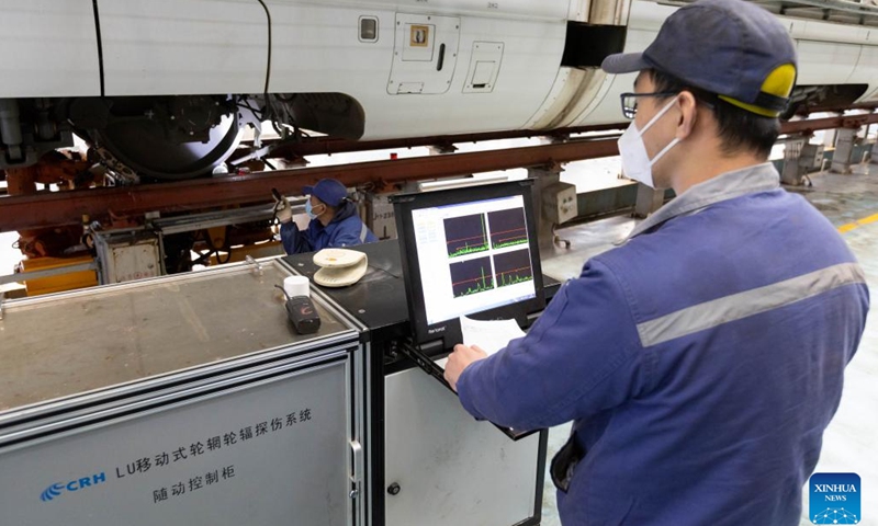 Workers carry out maintenance at the Hongqiao high-speed train depot in east China's Shanghai, Jan. 3, 2023. Railway workers of the Hongqiao high-speed train depot have stepped up their efforts on maintenance work for trains to prepare for the future travel rush during the Chinese Lunar New Year.(Photo: Xinhua)