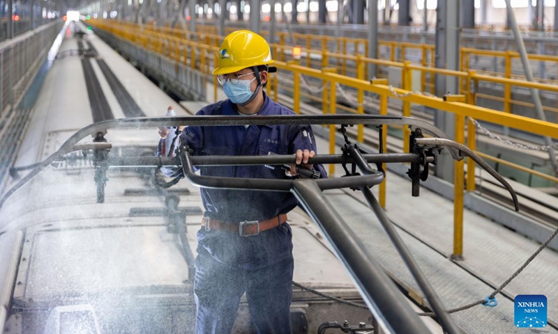 A worker carries out maintenance at the Hongqiao high-speed train depot in east China's Shanghai, Jan. 3, 2023. Railway workers of the Hongqiao high-speed train depot have stepped up their efforts on maintenance work for trains to prepare for the future travel rush during the Chinese Lunar New Year.(Photo: Xinhua)