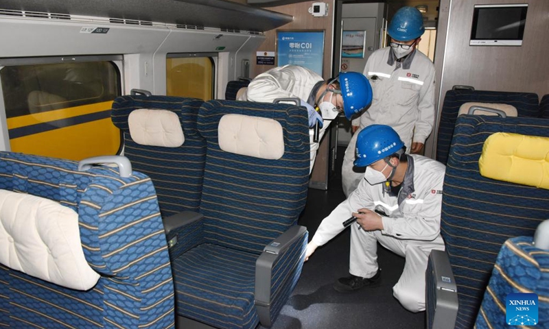 Technicians debug a train at a workshop of CRRC Qingdao Sifang Co., Ltd. in Qingdao, east China's Shandong Province, Jan. 4, 2023. As a major manufacturer of high-speed trains in China, CRRC Qingdao Sifang Co., Ltd. overhauled the trains that will serve the upcoming Spring Festival travel rush to ensure their smooth operation.(Photo: Xinhua)