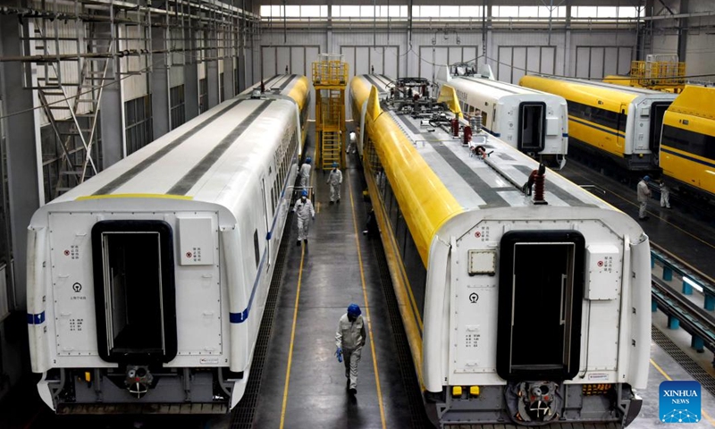 Technicians debug trains at a workshop of CRRC Qingdao Sifang Co., Ltd. in Qingdao, east China's Shandong Province, Jan. 4, 2023. As a major manufacturer of high-speed trains in China, CRRC Qingdao Sifang Co., Ltd. overhauled the trains that will serve the upcoming Spring Festival travel rush to ensure their smooth operation.(Photo: Xinhua)