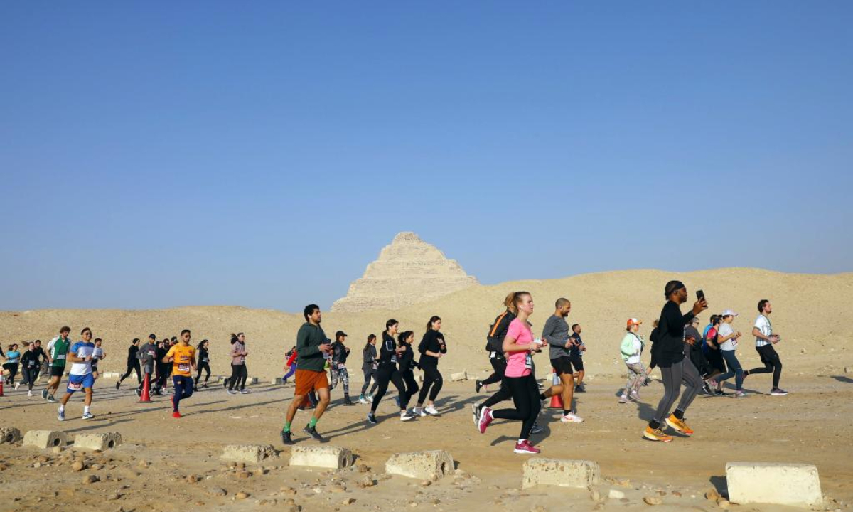 Runners participate in the Saqqara Pyramid Race in the Saqqara necropolis, south of the capital Cairo, Egypt, Feb. 17, 2023. The Saqqara Pyramid Race takes runners up close to Step Pyramid of Saqqara and offers two distances (5km and 10km). Photo:Xinhua