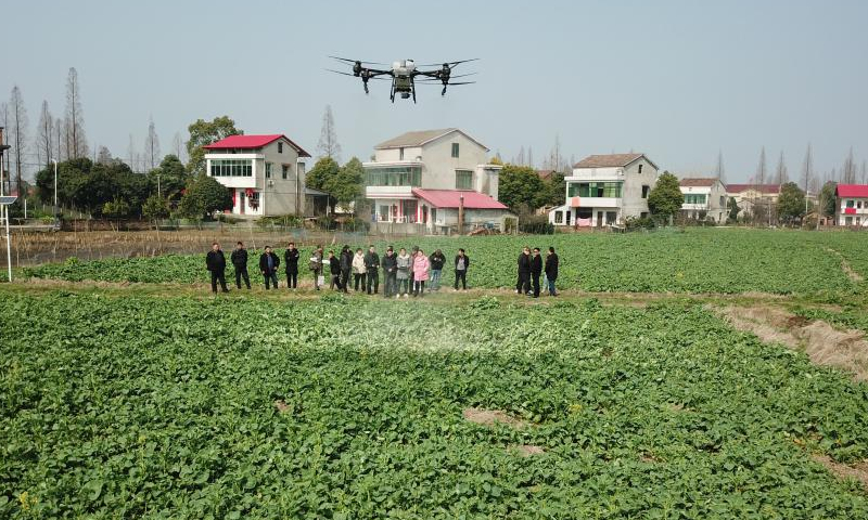 Trainees watch a drone takeoff demonstration in the field in Fu'an Village of Gonghua Town in Yuanjiang, central China's Hunan Province, Feb. 15, 2023. Fu'an Village conducted a drone operation training on Wednesday for local villagers to prepare for the spring ploughing. Photo: Xinhua
