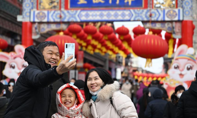 Tourists take a selfie at a traditional culture street in north China's Tianjin, Jan. 26, 2023. Photo: Xinhua