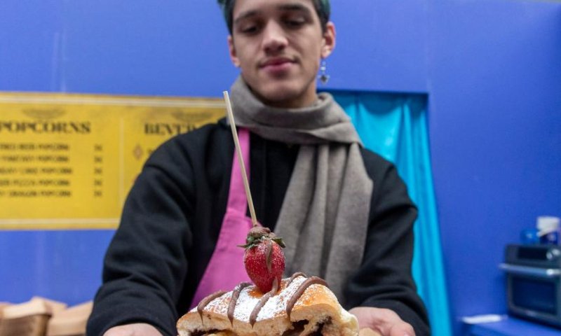An employee of a pastry shop presents a chocolate sweet at the 4th Chocolate Fest in Athens, Greece, Feb. 11, 2023. Photo: Xinhua