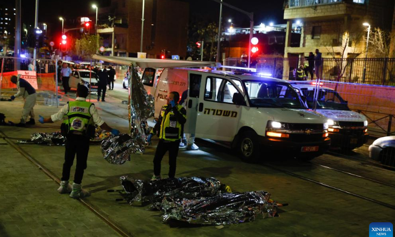 Israeli police and emergency service members work at the scene of a shooting attack in a settlement in East Jerusalem, on Jan. 27, 2023. At least eight people were killed and 10 others injured in a shooting attack in a settlement in East Jerusalem on Friday night, the Israeli Foreign Ministry said in a tweet. Photo: Xinhua