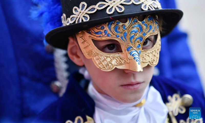 A child wearing a mask attends the Venice Carnival in Venice, Italy, on Feb. 5, 2023. The Venice Carnival 2023 kicked off in the Italian lagoon city on Feb. 4, and will last until Feb. 21. (Xinhua/Jin Mamengni)