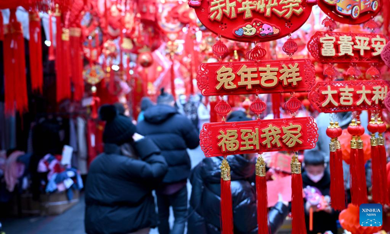 People shop for decorations for the upcoming Chinese New Year in Hefei, east China's Anhui Province, Jan. 5, 2023. (Xinhua/Huang Bohan)