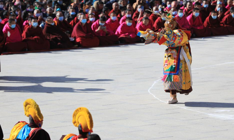 A masked monk performs religious dance during a ritual at the Labrang Monastery in Xiahe County, northwest China's Gansu Province, Feb. 4, 2023. The ritual was held here on Saturday to pray for good luck in the new year. Photo: Xinhua