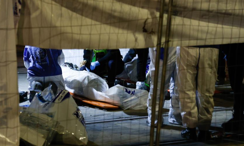 Israeli police and emergency service members work at the scene of a shooting attack in a settlement in East Jerusalem, on Jan. 27, 2023. At least eight people were killed and 10 others injured in a shooting attack in a settlement in East Jerusalem on Friday night, the Israeli Foreign Ministry said in a tweet. Photo: Xinhua