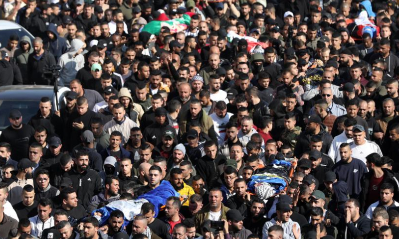 People carry the bodies of Palestinians killed by Israeli forces during a funeral in the West Bank city of Jenin, on Jan. 26, 2023. Israeli forces killed on Thursday at least nine Palestinians, including an elderly woman, during a raid in the occupied West Bank, Palestinian sources said, amid escalating violence in the region. Photo: Xinhua