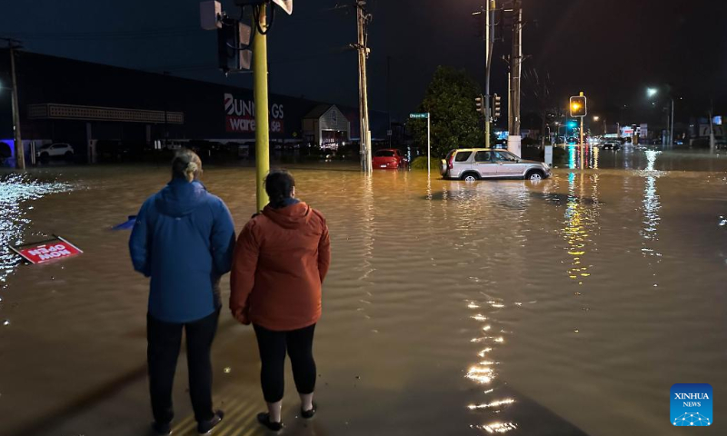 People look at a flooded street in Auckland, New Zealand, Jan. 27, 2023. A state of emergency was declared in Auckland on Friday as heavy rains caused widespread flooding in New Zealand's biggest city. Photo: Xinhua