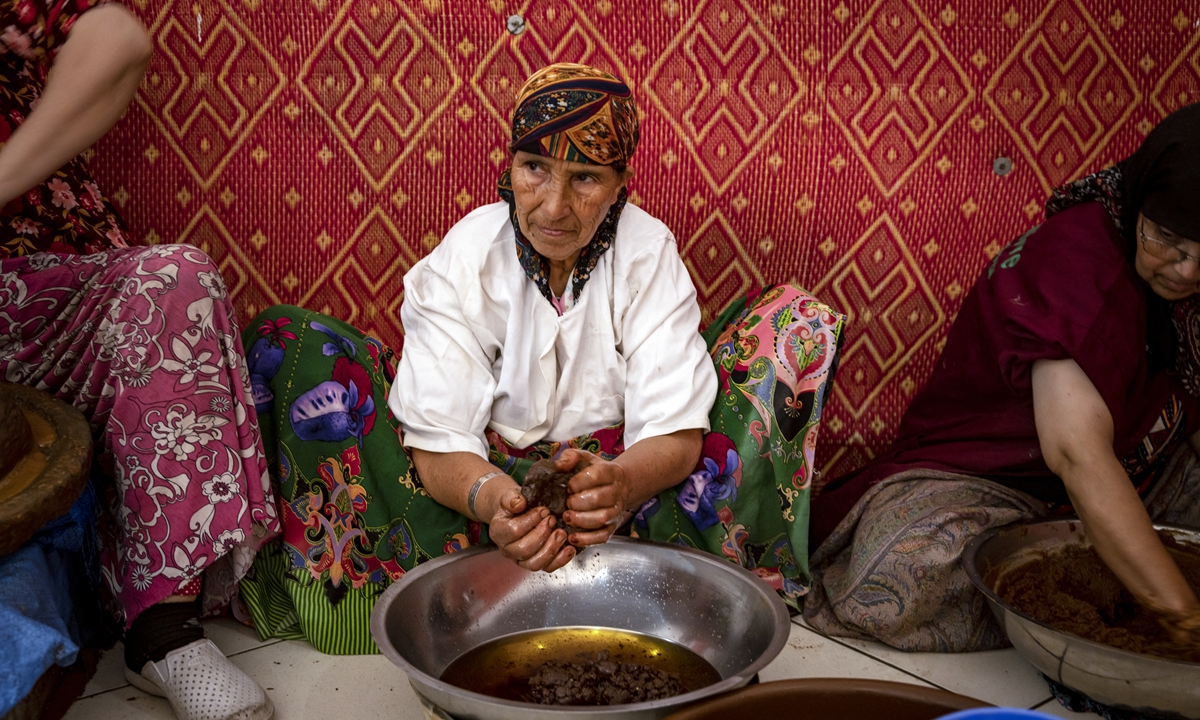 Women squeeze oil out of a paste made from crushed Argan nuts, near Morocco's western Atlantic coastal city of Essaouira. File photo: AFP