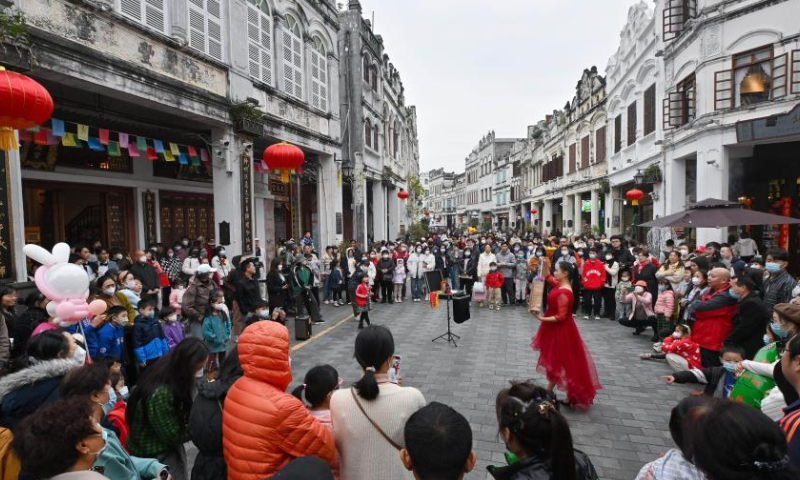 Tourists visit an exhibition at the Qilou ancient street during the Spring Festival holiday in Haikou, south China's Hainan Province, Jan. 27, 2023. Photo: Xinhua