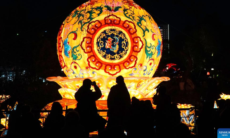 People enjoy the lantern show at the Baotu Spring Park in Jinan, capital city of east China's Shandong Province, Jan. 27, 2023. The lantern show held in Baotu Spring Park has attracted over 350,000 tourists during the Spring Festival holiday. Photo: Xinhua