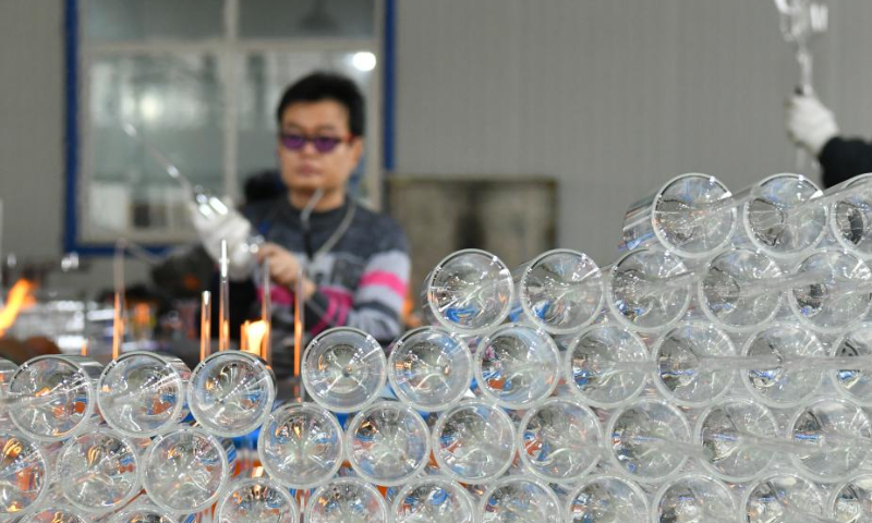 A worker makes a piece of glasswork at the workshop of a company in Hejian City, north China's Hebei Province, Feb. 11, 2023. Hejian City is famous for its glasswork making industry. Now, there are more than 200 glasswork making companies and over 60,000 staff members involved in the industry in Hejian. The annual output of the glasswork reached nearly 10 billion yuan (about 1.47 billion U.S. dollars) and the glasswork has been exported to over 50 countries and regions.Photo: Xinhua