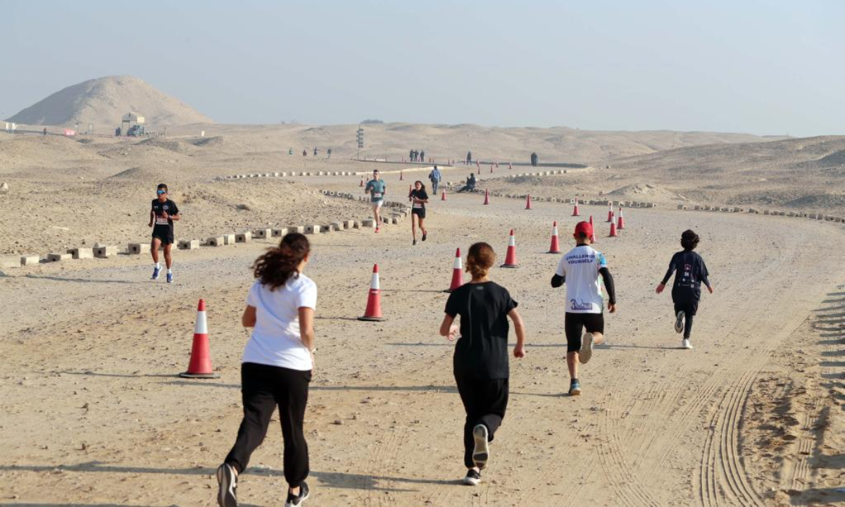 Runners participate in the Saqqara Pyramid Race in the Saqqara necropolis, south of the capital Cairo, Egypt, Feb. 17, 2023. The Saqqara Pyramid Race takes runners up close to Step Pyramid of Saqqara and offers two distances (5km and 10km). Photo:Xinhua