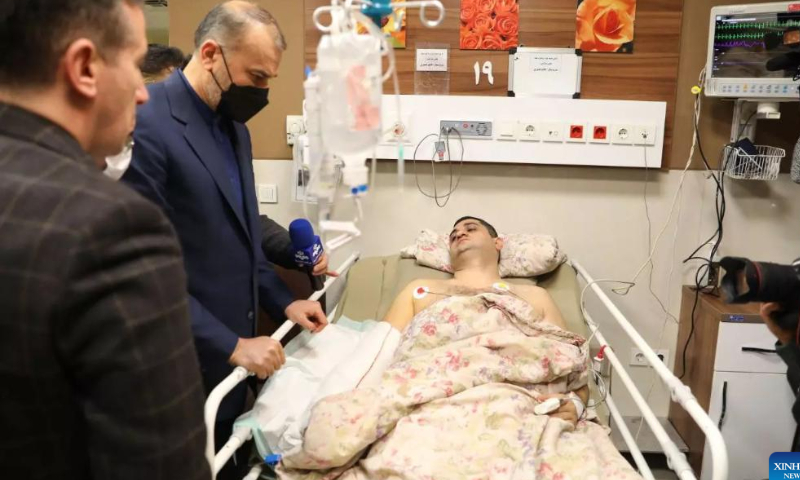 Iranian Foreign Minister Hossein Amir-Abdollahian (2nd L) visits an Azerbaijani embassy's guard wounded in an attack, at a hospital in Tehran, Iran, on Jan. 27, 2023. The Iranian foreign minister on Friday condemned the deadly armed attack on Azerbaijan's embassy in Tehran, saying the two countries should not let their ties be affected by the incident. Photo: Xinhua