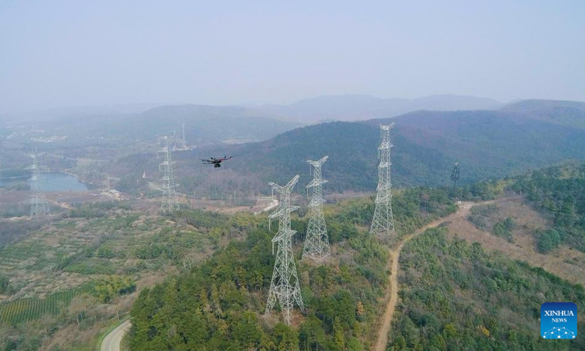 An unmanned drone with centimeter-level high-precision positioning capabilities inspects the automatic transmission lines of the electric transmission towers in east China's Jiangsu Province, Jan 4, 2023. Photo:Xinhua