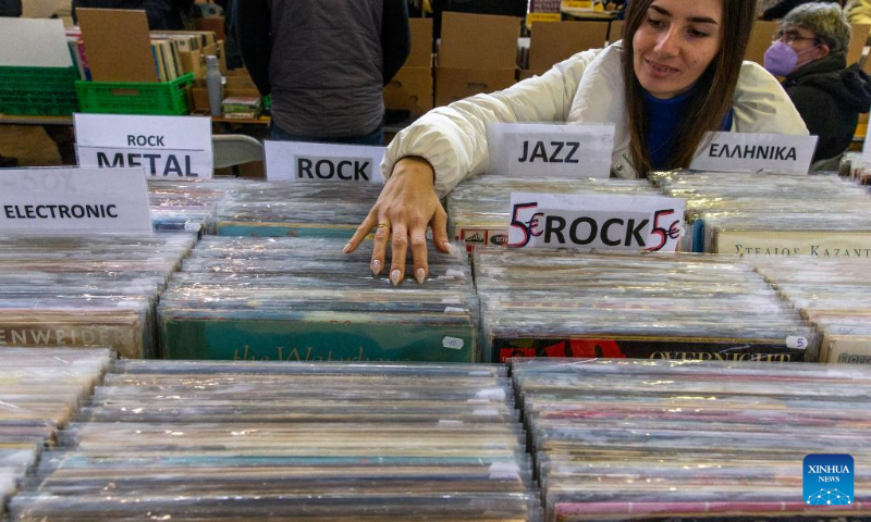 An employee of a record store is seen at the Vinyl Market annual event where people can buy rare vinyl records, at Technopolis City of Athens in Athens, Greece, on Feb. 5, 2023. (Xinhua/Marios Lolos)