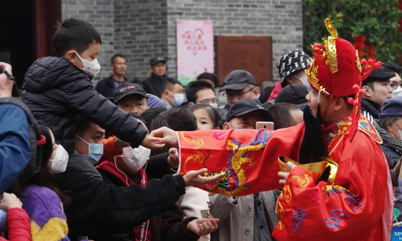 A staff member in the costume of the God of Wealth takes part in an event at a historic street in Nanning, south China's Guangxi Zhuang Autonomous Region, Jan. 26, 2023. Ceremonies were held to welcome the God of Wealth as a tradition on the fifth day of the Chinese Lunar New Year, which falls on Thursday this year. Photo: Xinhua