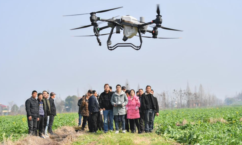 Trainees watch a drone takeoff demonstration in the field in Fu'an Village of Gonghua Town in Yuanjiang, central China's Hunan Province, Feb. 15, 2023. Fu'an Village conducted a drone operation training on Wednesday for local villagers to prepare for the spring ploughing. Photo: Xinhua