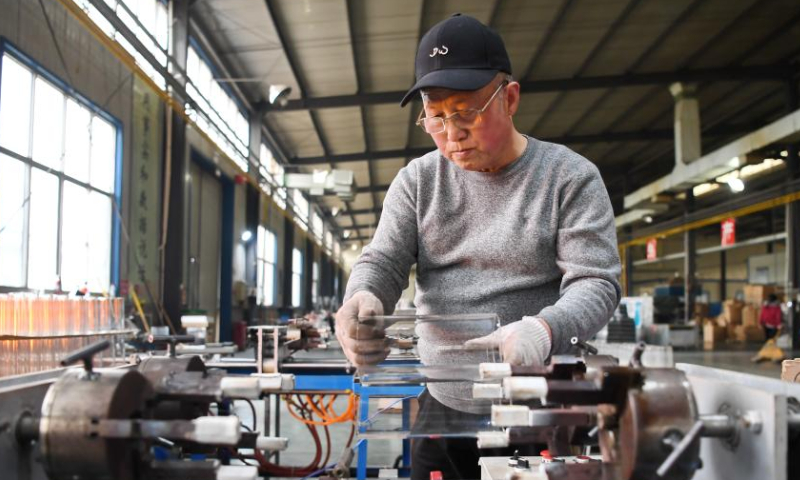 A worker makes a piece of glasswork at the workshop of a company in Hejian City, north China's Hebei Province, Feb. 11, 2023. Hejian City is famous for its glasswork making industry. Now, there are more than 200 glasswork making companies and over 60,000 staff members involved in the industry in Hejian. The annual output of the glasswork reached nearly 10 billion yuan (about 1.47 billion U.S. dollars) and the glasswork has been exported to over 50 countries and regions. Photo: Xinhua