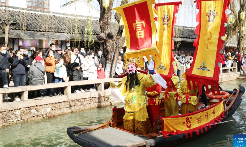 A staff member in the costume of the God of Wealth takes part in a parade along waterways at an ancient town in Suzhou, east China's Jiangsu Province, Jan. 26, 2023. Ceremonies were held to welcome the God of Wealth as a tradition on the fifth day of the Chinese Lunar New Year, which falls on Thursday this year. Photo: Xinhua
