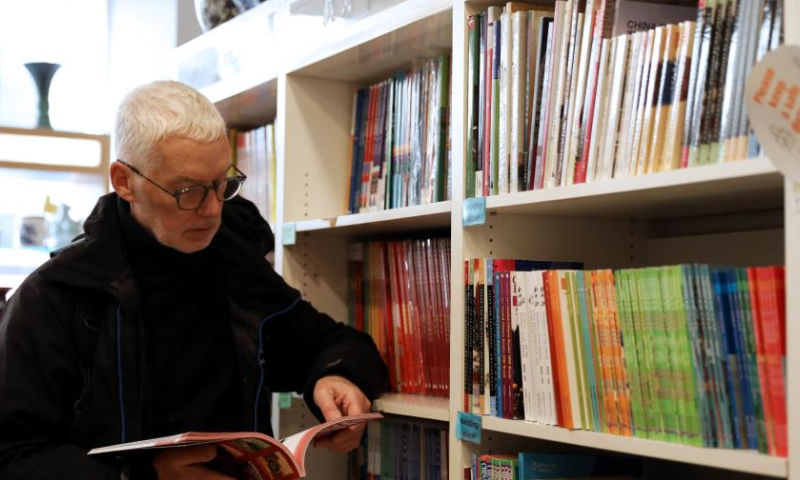 Marcus Broadbent reads at the Guanghwa Bookshop in London, Britain, Jan. 24, 2023. Photo: Xinhua