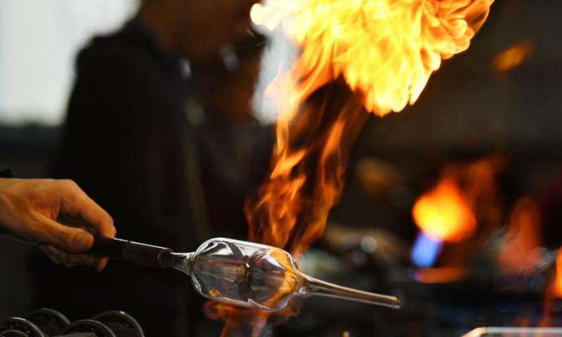 A worker makes a piece of glasswork at the workshop of a company in Hejian City, north China's Hebei Province, Feb. 11, 2023. Hejian City is famous for its glasswork making industry. Now, there are more than 200 glasswork making companies and over 60,000 staff members involved in the industry in Hejian. The annual output of the glasswork reached nearly 10 billion yuan (about 1.47 billion U.S. dollars) and the glasswork has been exported to over 50 countries and regions. Photo: Xinhua