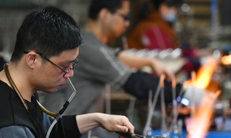 Workers make glasswork at the workshop of a company in Hejian City, north China's Hebei Province, Feb. 11, 2023. Hejian City is famous for its glasswork making industry. Now, there are more than 200 glasswork making companies and over 60,000 staff members involved in the industry in Hejian. The annual output of the glasswork reached nearly 10 billion yuan (about 1.47 billion U.S. dollars) and the glasswork has been exported to over 50 countries and regions. Photo: Xinhua