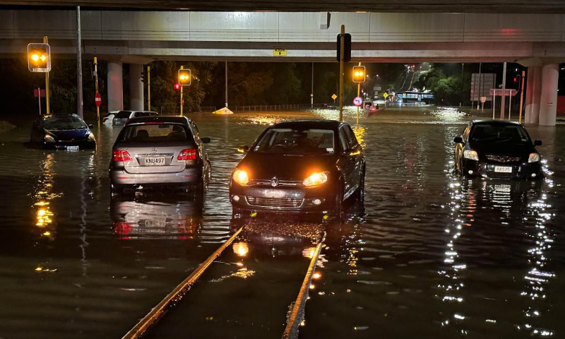 Vehicles drive on a flooded street in Auckland, New Zealand, Jan. 27, 2023. A state of emergency was declared in Auckland on Friday as heavy rains caused widespread flooding in New Zealand's biggest city. Photo: Xinhua