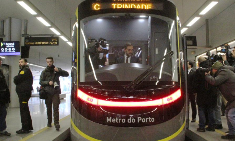 Portuguese Minister of Environment and Climate Action Duarte Cordeiro (C) sits in the driver's cab of a China-made metro train inside the Trindade Metro Station at the center of Porto, Portugal, Feb. 11, 2023. First of the 18-set metro trains made by Chinese company was delivered to the Porto Metro company of Portugal on Saturday. Photo: Xinhua
